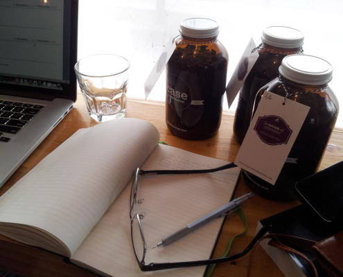 Desk filled with writing materials and coffee